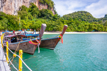 Fototapeta na wymiar Typical thai boats over the sandy beach