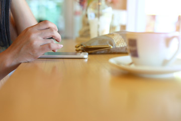 female using mobile phone in coffee cafe