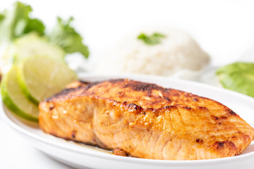 Grilled salmon steak with salad and rice