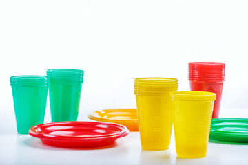 A set of plastic dishes for a picnic on white background with copy space.
