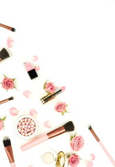 Makeup cosmetic accessories products  brushes, lipstick, pink flowers roses on white background. Flat lay. Top view. Copy space