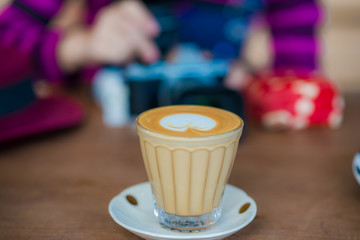 Beautiful smiling asian women drinking hot latte art coffee