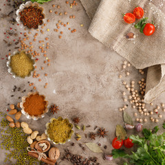 Fresh greens and tomatoes cereals spices and nuts organic healthy snacks on a textural background. The concept of healthy eating. Lean foods. Copy space.