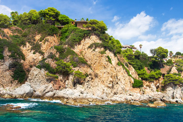 Sea coast of Costa Brava on sunny summer day. Scenic view on rocky shore
