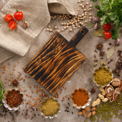 Fresh greens and tomatoes spices cereals and nuts organic healthy snacks on a textural background....