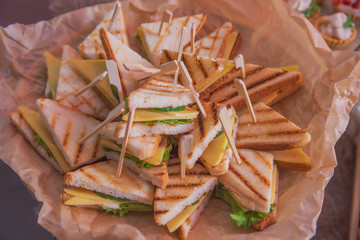 Tasty and juicy snacks for buffet table: mini burgers, canapés, fruit, sliced and baked