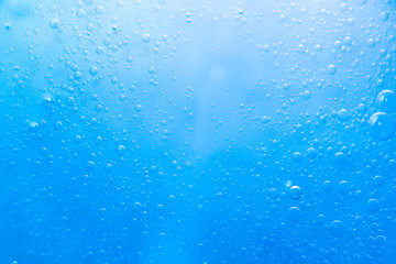 Obraz premium Air bubbles in the water background.Abstract oxygen bubbles in the sea.Circle foamy air in the ocean.Water bubbles isolate on blue background