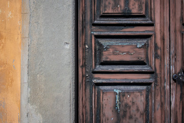 Background texture of an old brown wooden door and cement wall