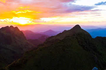 Fototapeta na wymiar Silhouette sunset on mountain with colorful sky cloud