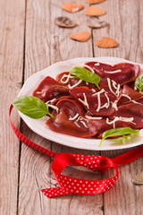 Red heart ravioli with tomato, mozzarella and basil.