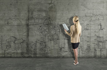 Obraz na płótnie Canvas Young woman drawing a business sketch on a concrete wall. 3d render elements in collage