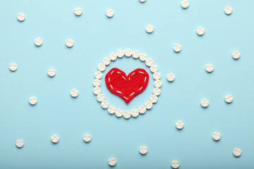 Aspirin tablets and red heart. Cardiology and medicine, healthcare and pharmacy concept.