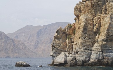 Picture of colored rocky mountains, cliffs along the coast of Oman