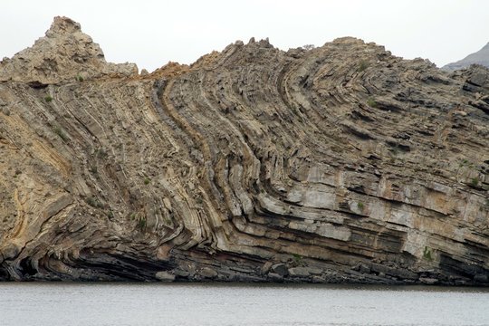 Details of unique compressed rock layers formation in various colors and thicknesses it shows how violent was the past of earth. Nature and Geological science concept.