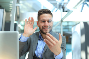 Transparent phones of the future concept, a Caucasian businessman having a video call.