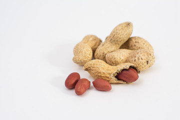 Dried peanuts close-up on a white background. Peanuts without shells. Healthy vegetarian food. The...