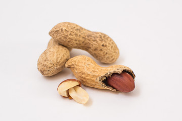 Dried peanuts close-up on a white background. Peanuts without shells. Healthy vegetarian food. The...