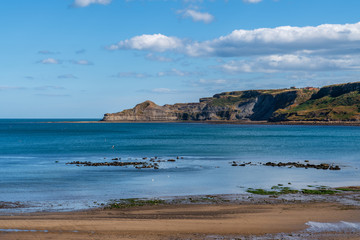 North Sea Coast in North Yorkshire, England, UK - looking from Runswick Bay towards the former quarry in Kettleness Point
