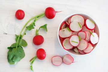 Red Radish salad in white bowl. Healthy eating. Top view image.
