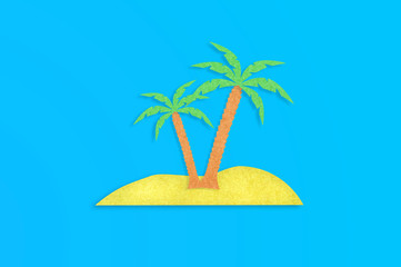 Two palm trees with leaves and yellow island cut out from paper on blue table. Top view. Minimalism concept - Image