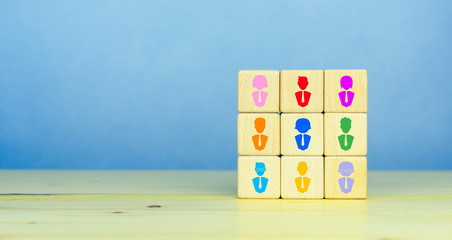 Building a good and strong team, recruitment business and human resources concept, wooden blocks with people icon on table, blue background, copy space