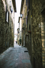 Fototapeta na wymiar Narrow street on a medieval town in Tuscany
