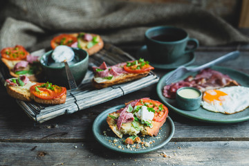 rustic breakfast, baked with basil, tomato, salami and cheese slices of bread, fried egg and bacon