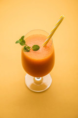 Musk melon juice with slice, also known as Kharbuj/kharbuja fruit extract, served in a glass with mint. selective focus