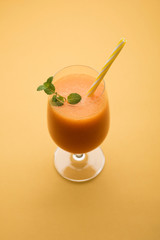 Musk melon juice with slice, also known as Kharbuj/kharbuja fruit extract, served in a glass with mint. selective focus