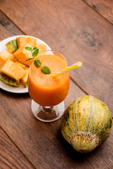 Musk melon juice with slice, also known as Kharbuj/kharbuja fruit extract, served in a glass with mint. selective focus