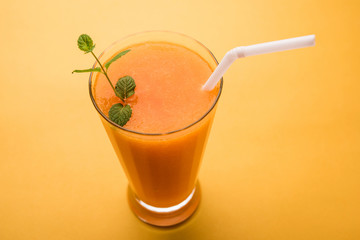 Musk melon juice with slice, also known as Kharbuj/kharbuja fruit extract, served in a glass with mint. selective focus