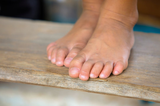 Elegant bare feet of girls,Bare feet with wooden floor
