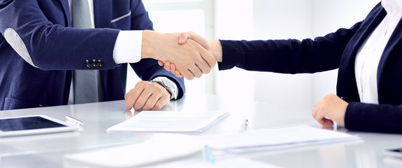 Group of business people or lawyers shaking hands finishing up a meeting , close-up. Success at negotiation and handshake concepts