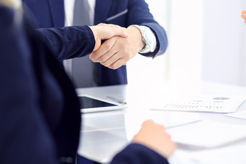 Group of business people or lawyers shaking hands finishing up a meeting , close-up. Success at negotiation and handshake concepts
