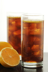Glasses with cuba libre cocktail or cola with ice or cold tea with lemon