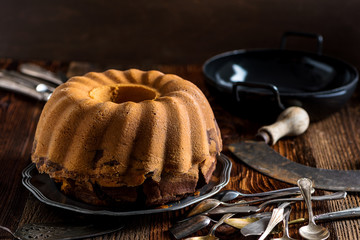 Delicious home-baked marble cake served on a wooden board with rustic decoration (baked by Alina Tschemernjak)