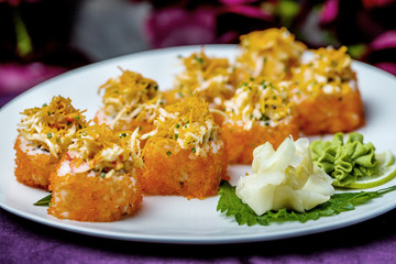 Sushi rolls, sashimi, exotic food, sushi on a white plate on a multi-colored background