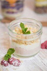 Raspberry with cream dessert, pudding on an old vintage wooden stand