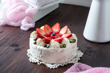 Delicious homemade cake with fruit and cream decorated with fresh fruits (baked by Alina Tschemernjak)