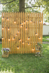 Fototapeta premium Wooden photozone with a lamp for a party and a photo shoot