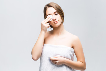 Model with natural make-up clean her face with white sponge on eye! Closeup photo!