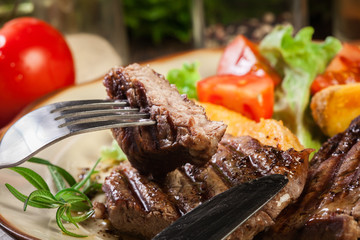 Succulent portions of grilled fillet mignon served with baked potatoes