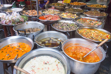 variety of Thai street food on a market stall
