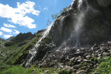 Mountain waterfall in sunny day. Altai mountains, Siberia, Russia