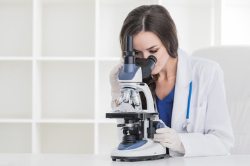 Young scientist with microscope