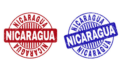 Grunge NICARAGUA round stamp seals isolated on a white background. Round seals with grunge texture in red and blue colors. Vector rubber imitation of NICARAGUA text inside circle form with stripes.