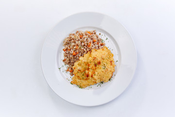 fried chicken breast with buckwheat on the white background