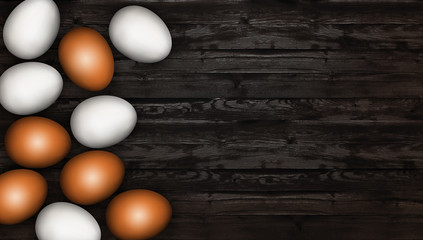 Close up of white and brown easter eggs on wooden background. Easter eggs on a wooden table. Dark rustic background. Invitation template design, greeting card, place for text