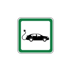 Green Road sign of car charging station