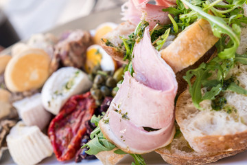 Healthy fresh dish with typical Maltese food with ham and raw spring or summer mediterranean vegetables